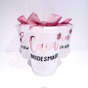 Transparant sparkly cold cup for bridesmaids and flower girls. Personalised with name in a metallic rose gold print and matching bow. Also the role is printed in black.