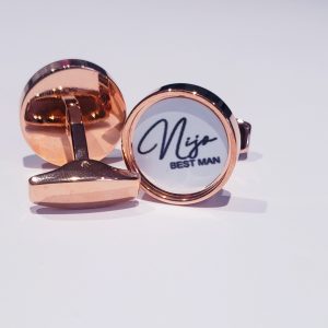 Round rose gold cufflinks with name and role printed in blaclk on a white background