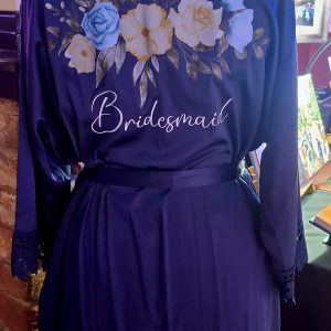 Navy lace edge robe with blue and yellow flowers and the word bridesmaid.