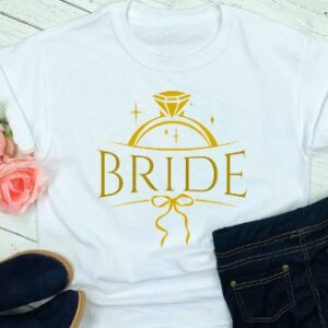 Ladies whit t-shirt with the word bride printed and featuring a diamond ring design in gold