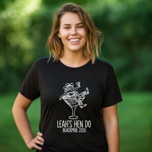 Ladies black t-shirt with a cocktal glass with a woman inside dressed as a cow girl and the wrording Leah's Hen Do printed in white